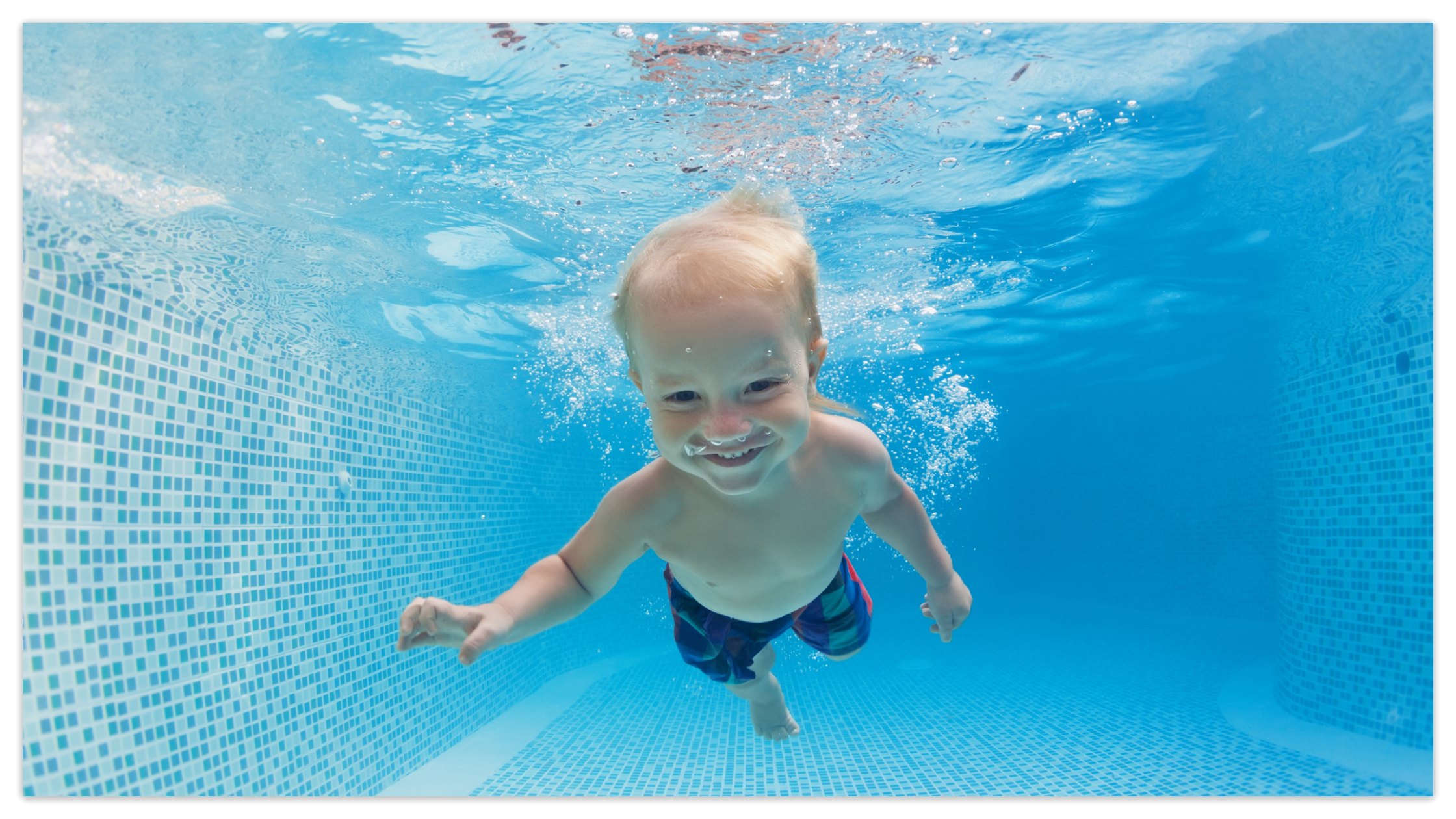 Baby learning to swim in the pool