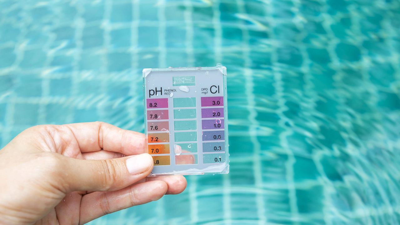 Checking pool pH level with a water testing kit