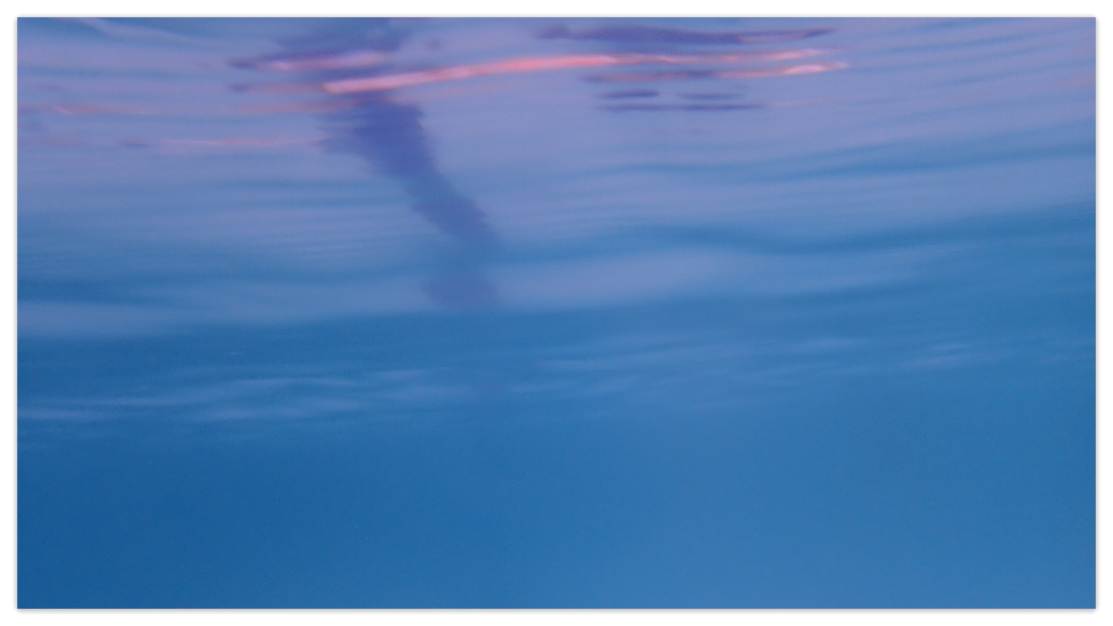 Cloudy pool water is blurry with blue hues.