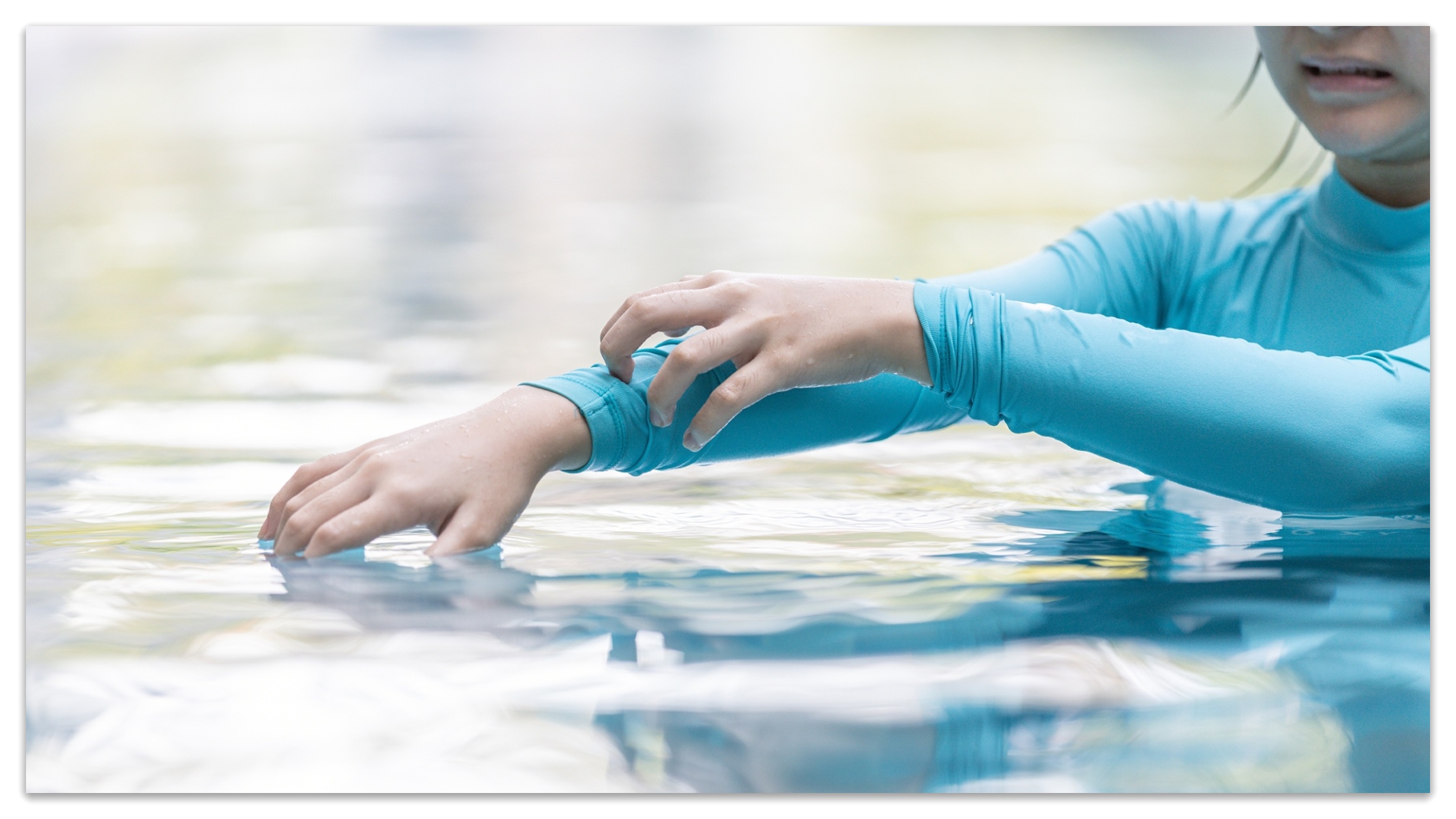 A girl scratches her skin that is irritated by pool water.
