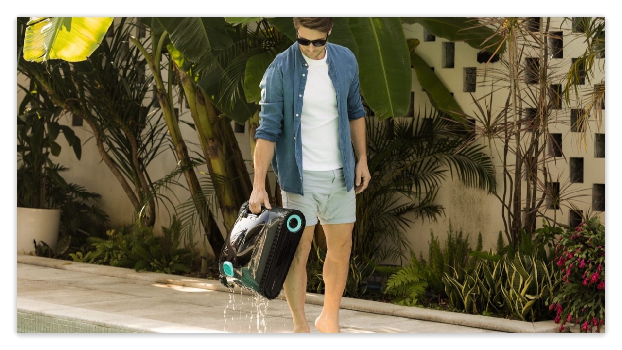 A person on the shore easily pull out the swimming pool robot with one hand.