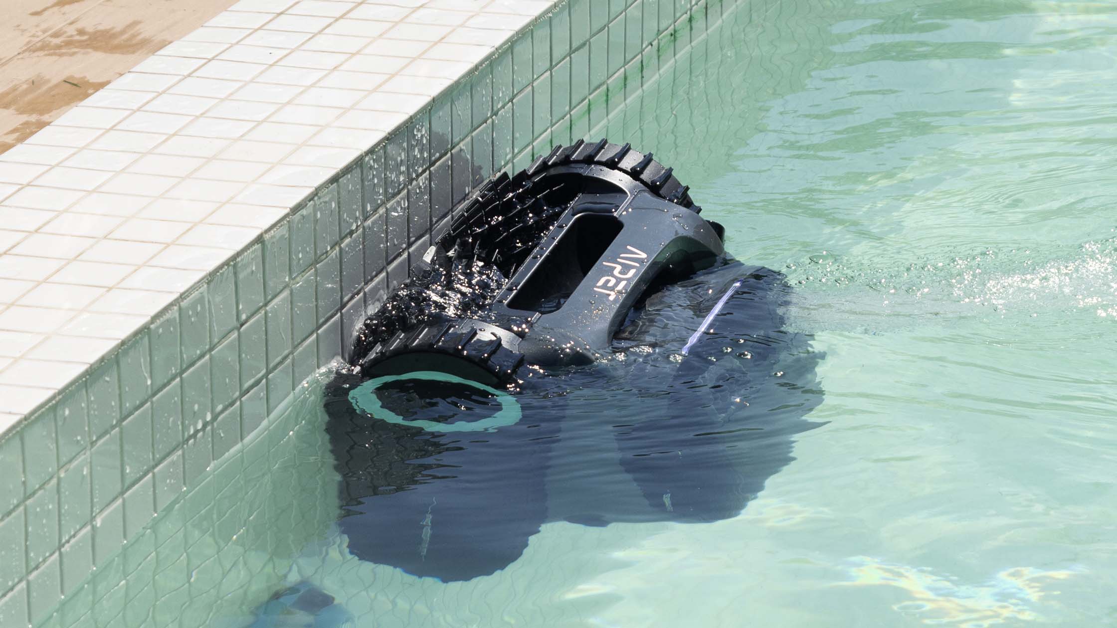 Robotic pool cleaner cleans waterline and the pool tiles.