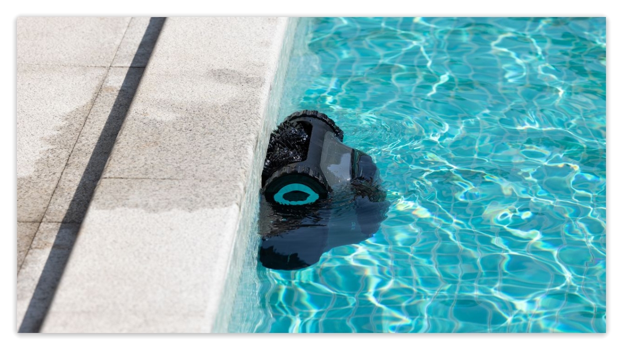 Submerged robotic cleaner on pool edge
