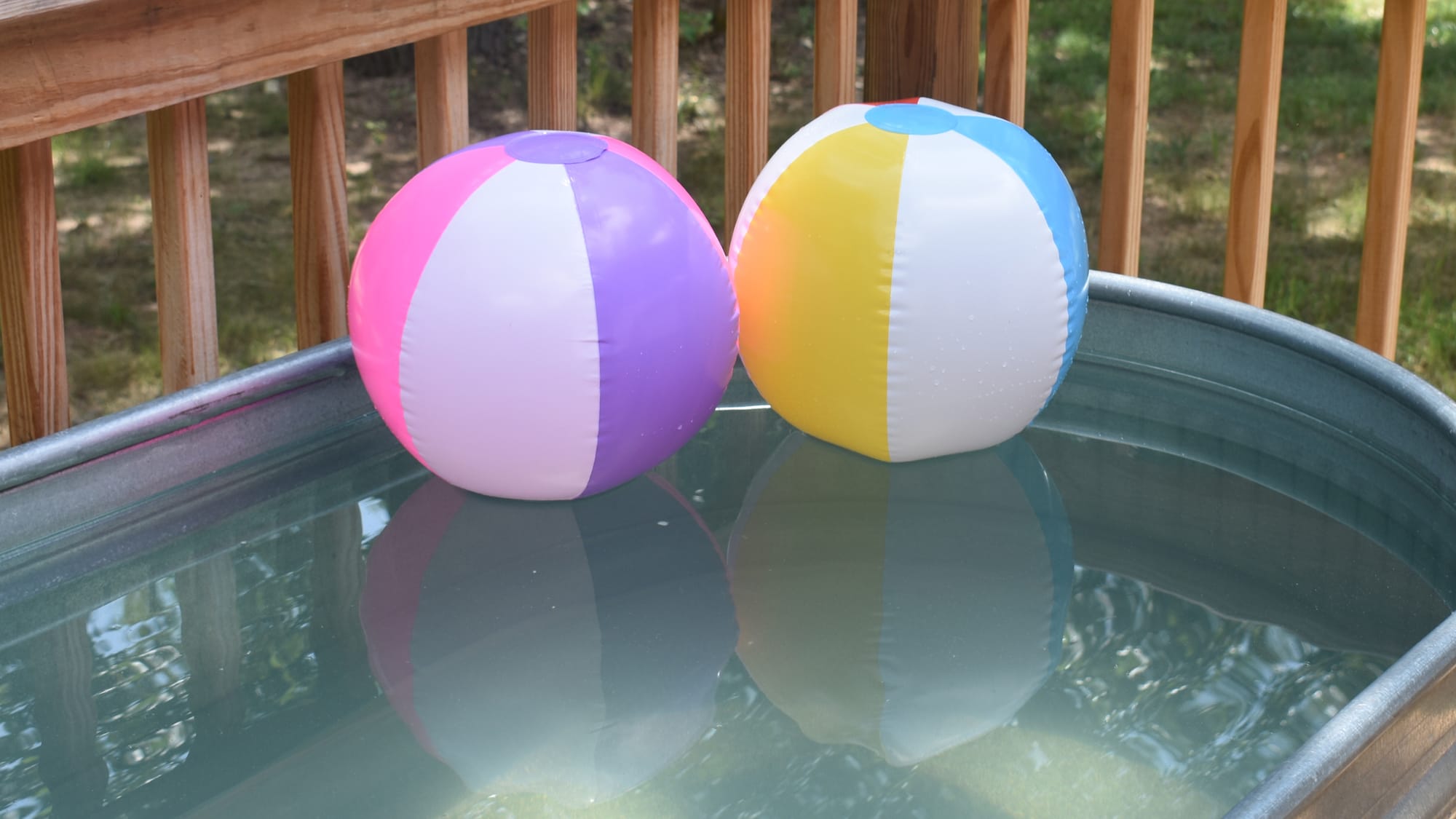 two pool balls float in a stock tank pool